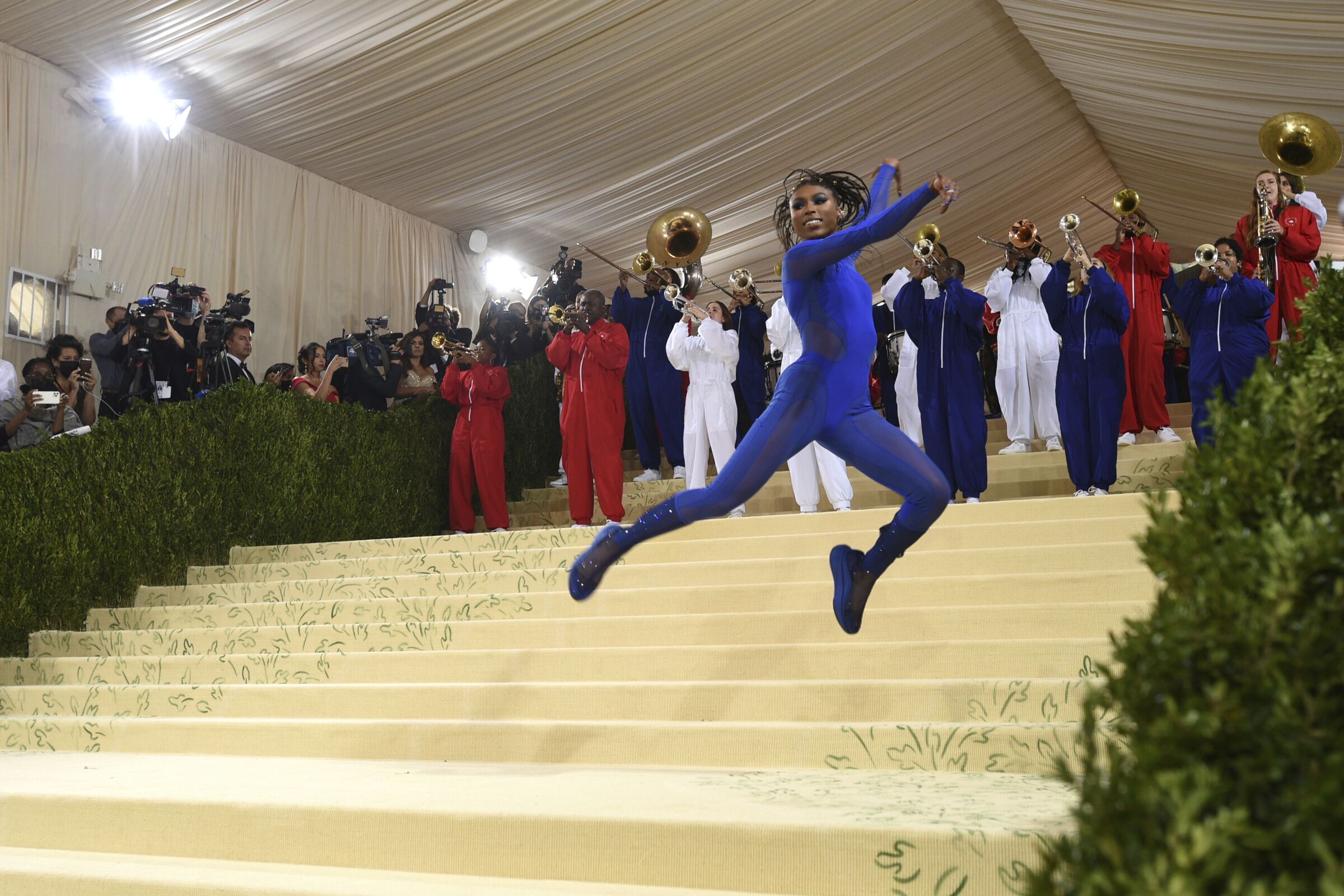Nia Dennis performs a gymnastics routine, backed by the Brooklyn United marching band, as she arrives at the Met Gala