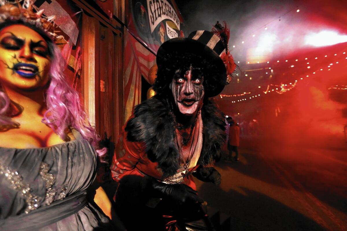 Oceana, left, and the Ring Master greet visitors to Dark Harbor, the annual Halloween festivity on the Queen Mary in Long Beach.