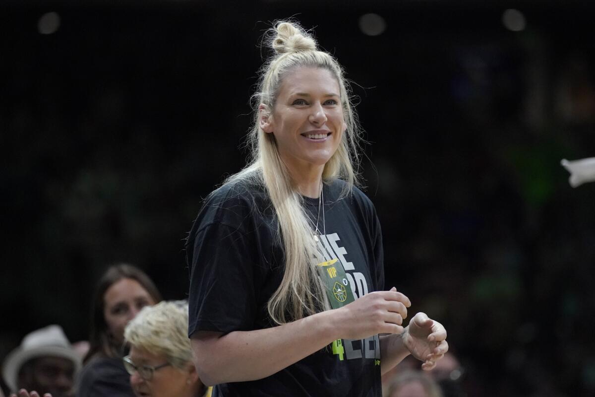 Former Seattle Storm center Lauren Jackson stands courtside before a WNBA basketball game between the Storm and the Minnesota Lynx, Wednesday, Aug. 3, 2022, in Seattle. Jackson attended the game in honor of the final season of Storm guard Sue Bird. (AP Photo/Ted S. Warren)