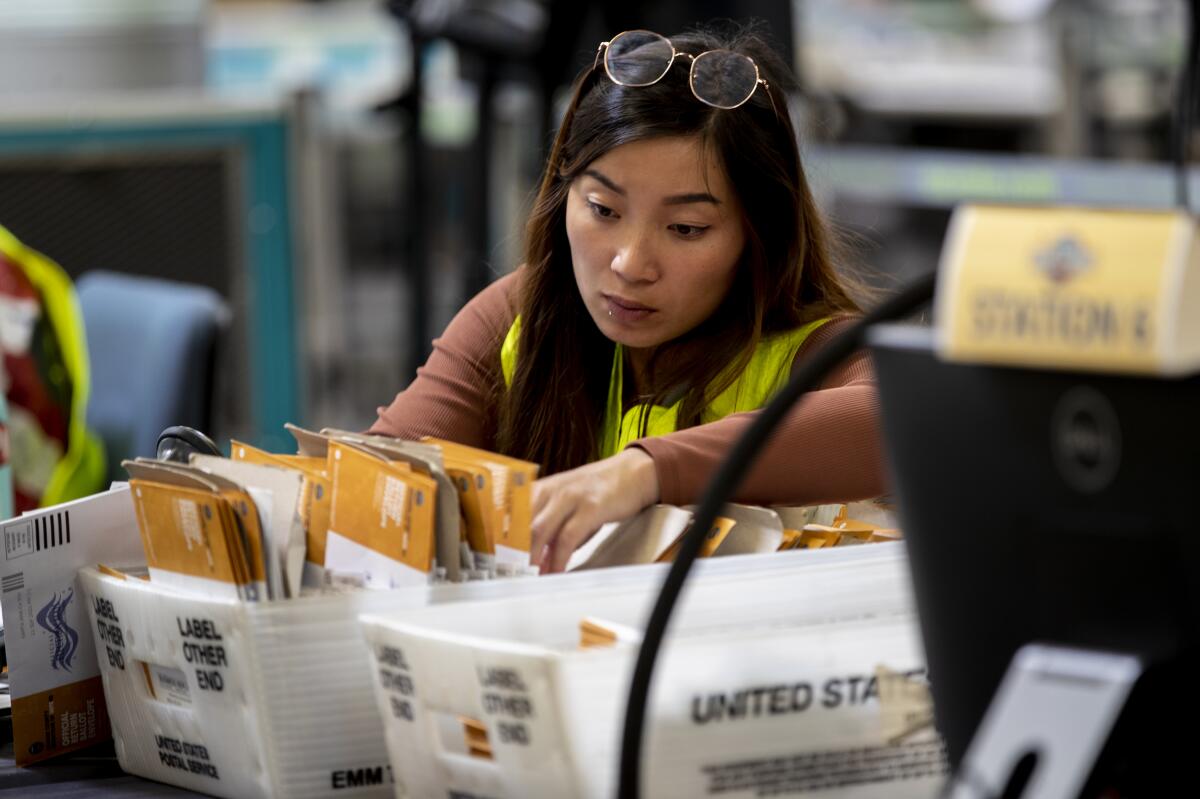An election worker verifies signatures