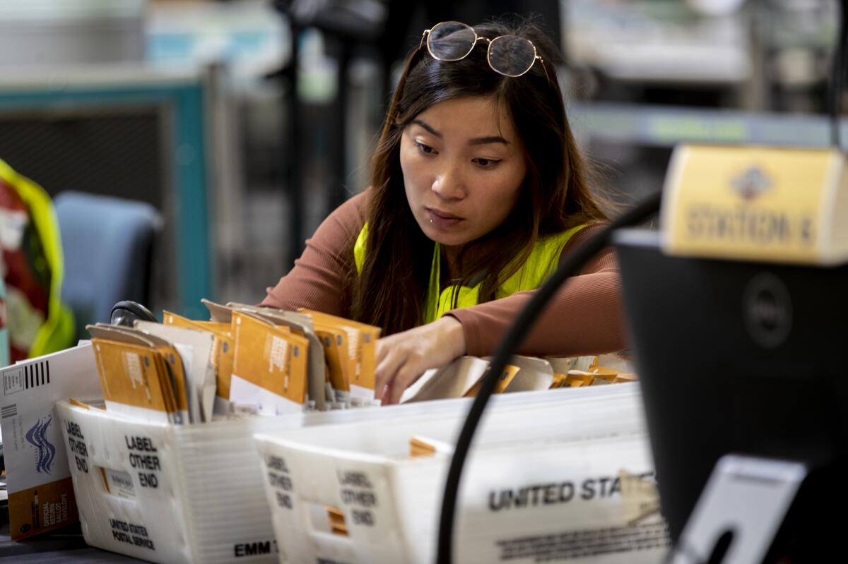 An election worker verifies signatures 