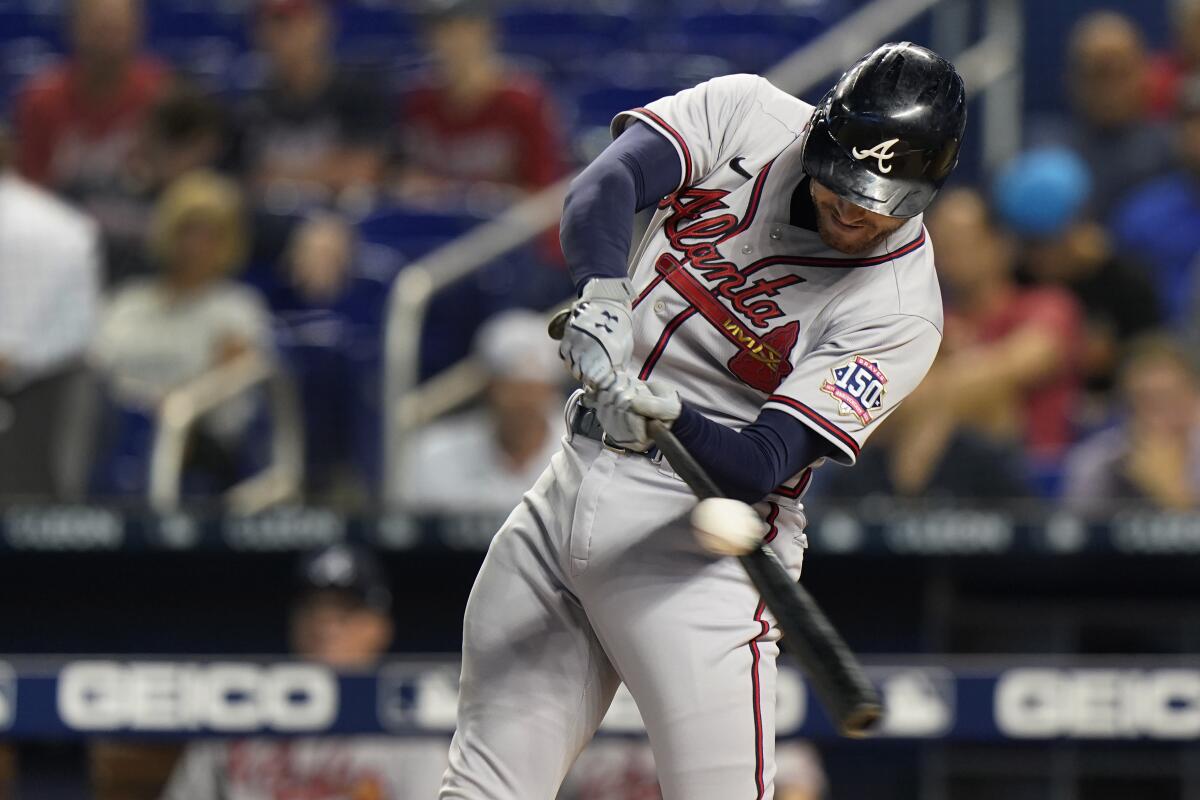 Atlanta Braves' Freddie Freeman hits the ball for a single during the first inning of the team's baseball game against the Miami Marlins, Tuesday, Aug. 17, 2021, in Miami. (AP Photo/Wilfredo Lee)