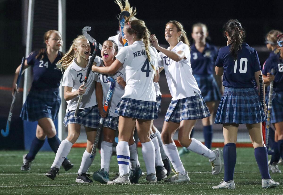 Newport Harbor's Bridget Taketa is celebrated by her teammates after tipping in a goal.