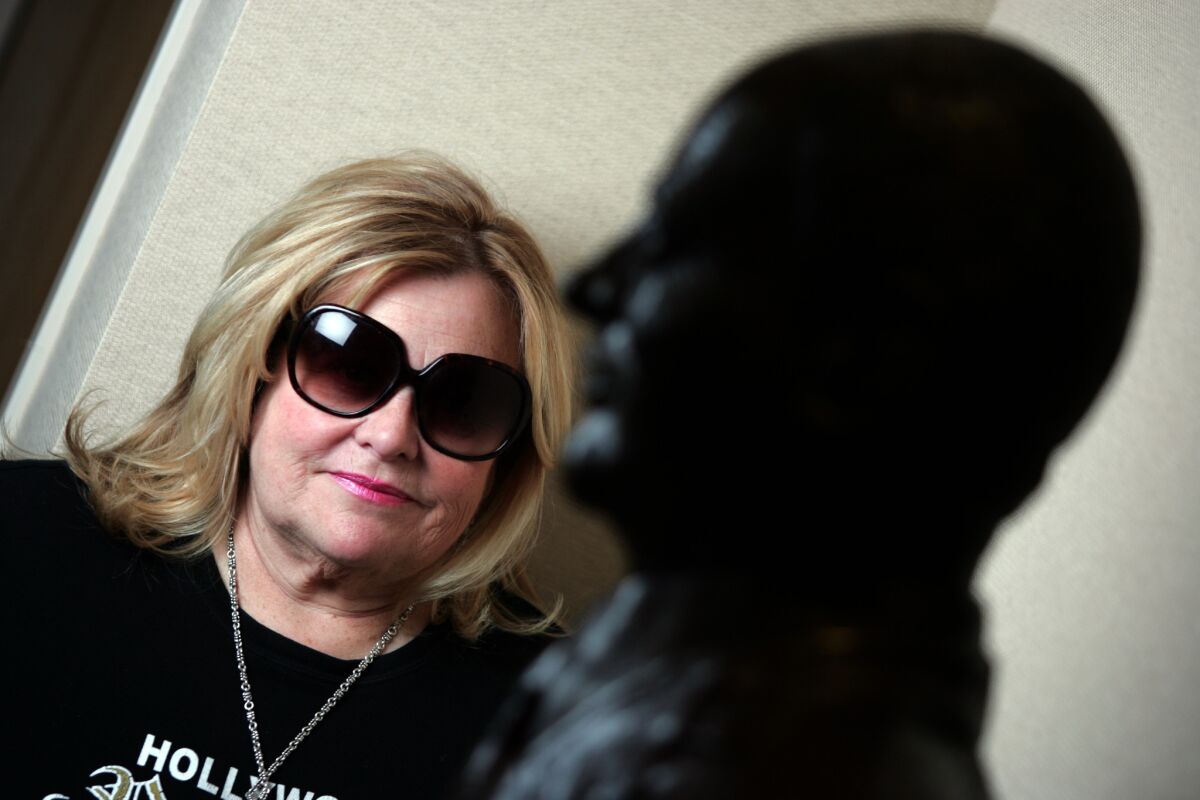 Francesca Hilton stands behind a statue of her father, Conrad Hilton, at the office of the Hilton Family Foundation in Century City in 2007.