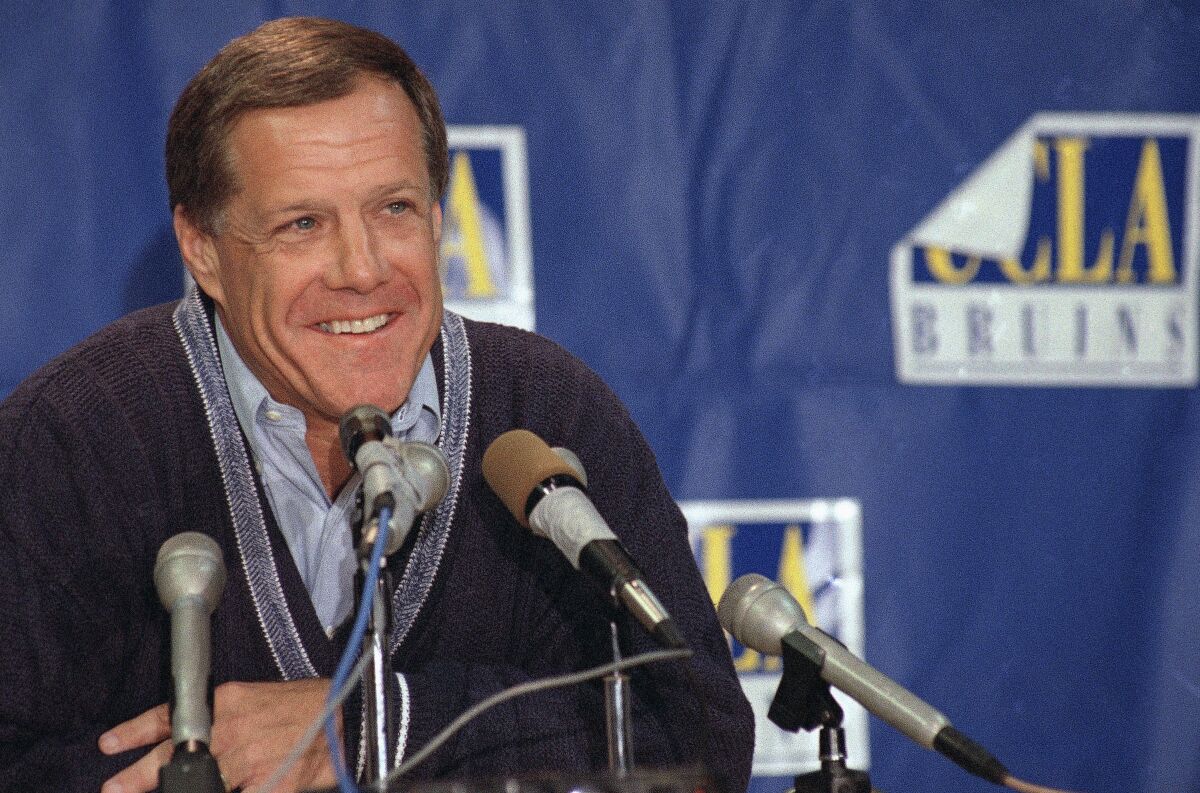 FILE - In this Dec. 11, 1995, file photo, Terry Donahue, the all-time leader in victories at UCLA and in the Pac-10, announces his resignation as head football coach, in Los Angeles. Donahue, the winningest coach in Pac-12 Conference and UCLA football history who later served as general manager of the NFL’s San Francisco 49ers, died Sunday, July 4, 2021. He was 77. (AP Photo/Nick Ut, File)