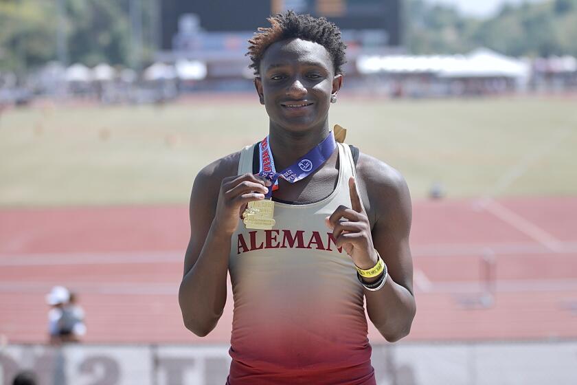 Bishop Alemany freshman Demare Dezeurn displays his medal.