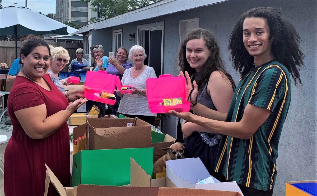 Members of the Harbor Lions Club assemble back-to-school kits during an Aug. 14 packing party.