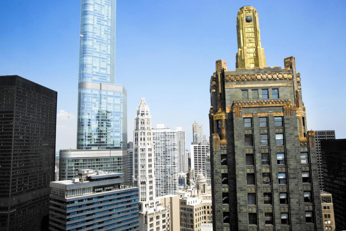 The Carbide and Carbon building, right, is an art deco skyscraper that once housed the Hard Rock Hotel and will now be home to St. Jane, another Michigan Avenue lodging.