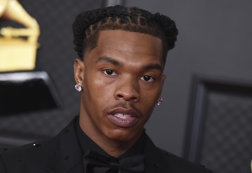 Rapper Lil Baby, with braided hair and pink diamond earrings, at the Grammy Awards in March