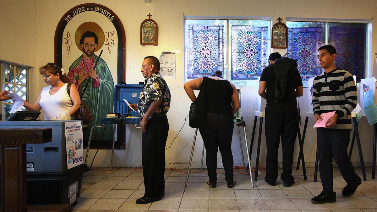 Voters make their way in and out of a polling place at the House of Mercy in Los Angeles in November 2012.