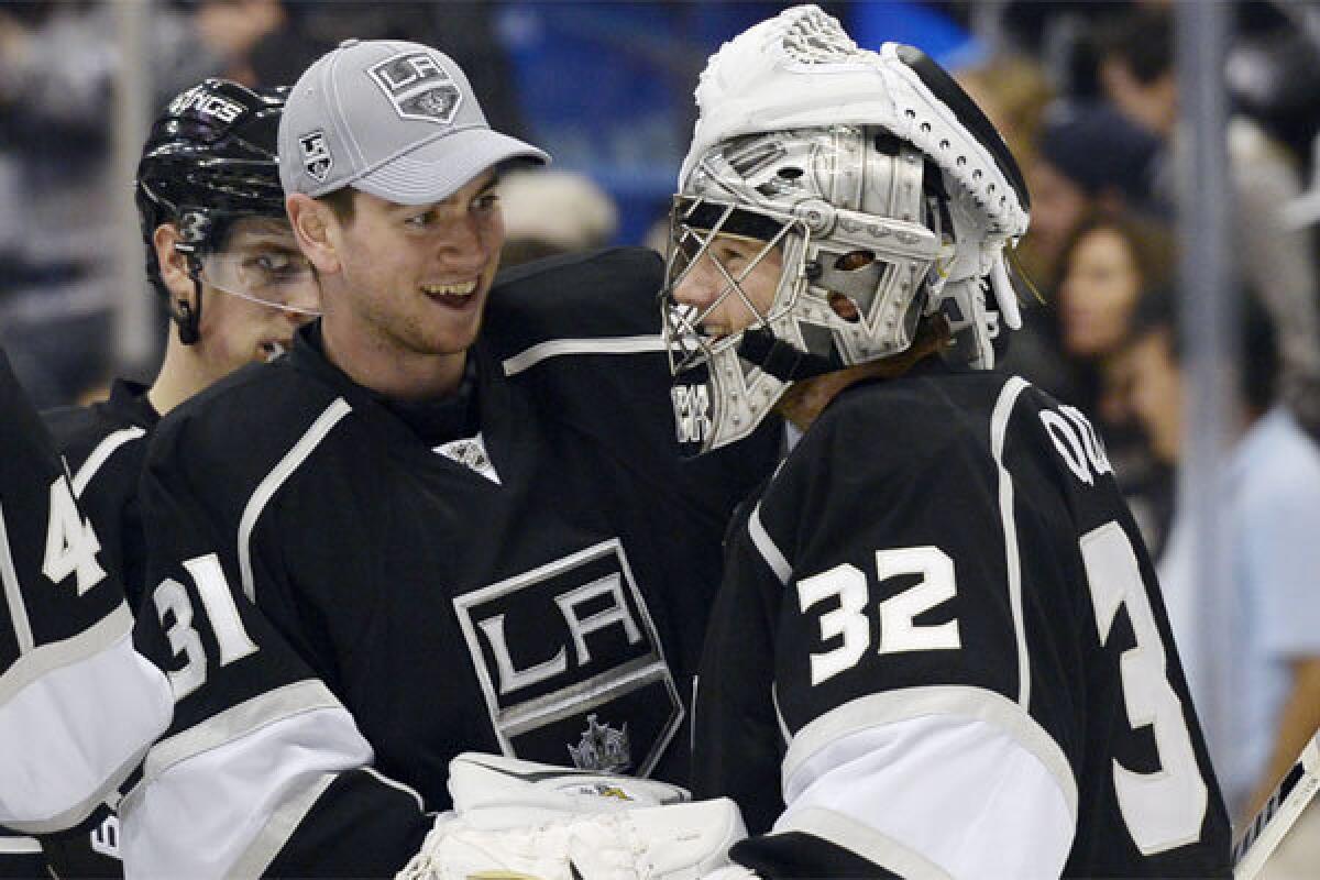 Kings goalie Jonathan Quick celebrates with backup Martin Jones after a 4-2 win over Winnipeg on Saturday.