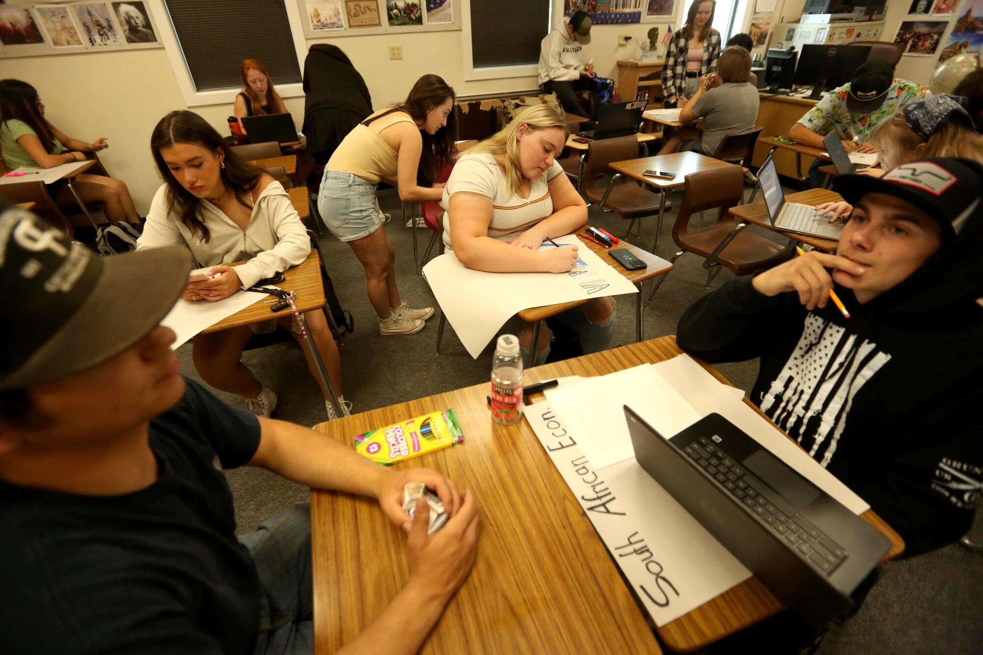 Students work on an exercise together during economics class at Modoc High School in Alturas.