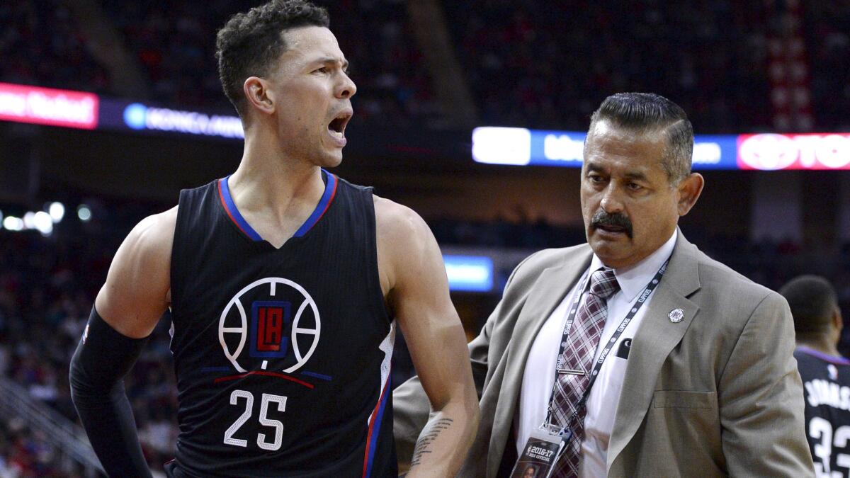 Clippers guard Austin Rivers is escorted off the court after being ejected during the second quarter Friday night in Houston.