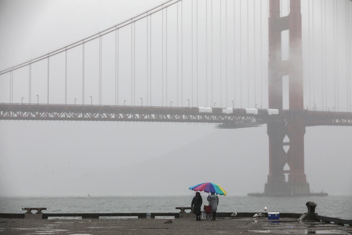 A misty view of the Golden Gate Bridge can be seen from Torpedo Wharf 