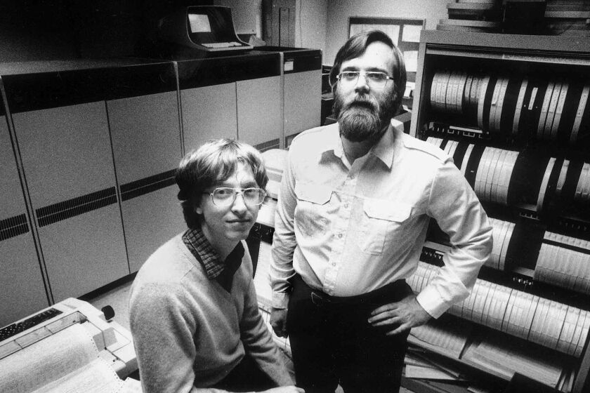 In 1981, computers the size of refrigerators and cabinets of tapes for reeltoreel computer tape drives lined the walls in the small offices of Microsoft founders Bill Gates, left, and Paul Allen in Bellevue, Wash. In 1981 Microsoft employed 85 people. Since then Microsoft has moved toneighboring Redmond, Wash., and now employs 27,000 people. (AP Photo/Eastside Journal, Jim Hallas) MANDATORY CREDIT