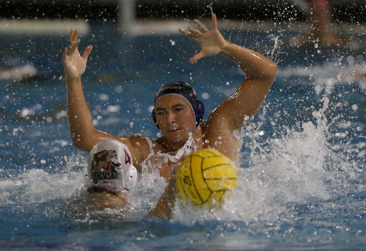 Newport Harbor's Makoto Kenney, top, pressures Oaks Christian's Andrew Outcalt in the first round of the CIF Southern Section Division 1 playoffs on Thursday.