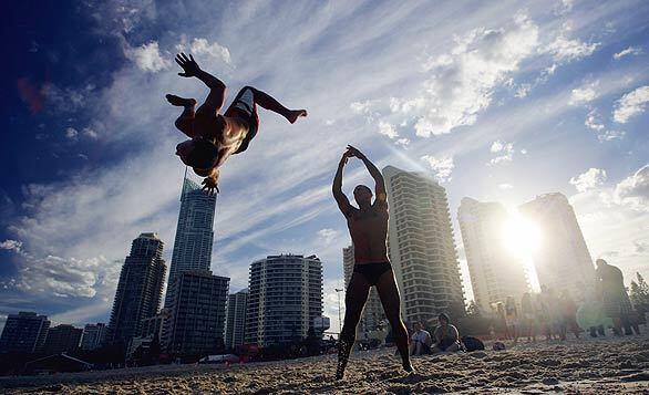 Schoolies -- recent high school graduates -- play on the beach at Surfers Paradise on Australia's Gold Coast. Schoolie celebrations, often accompanied by inebriated antics, break out annually in Australia as soon as students have finished their high school exams.