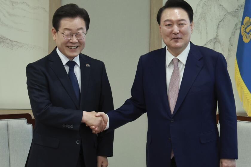 South Korean President Yoon Suk Yeol, right, shakes hands with main opposition Democratic Party leader Lee Jae-myung during a meeting at the presidential office in Seoul South Korea, Monday, April 29, 2024. (Hong Hae-in/Yonhap via AP)