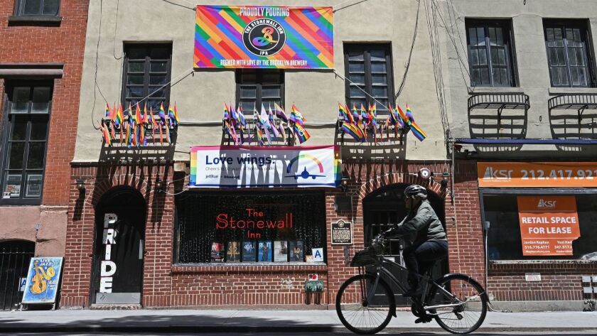 A biker passes the Stonewall Inn, now a National Historic Landmark, in New York.