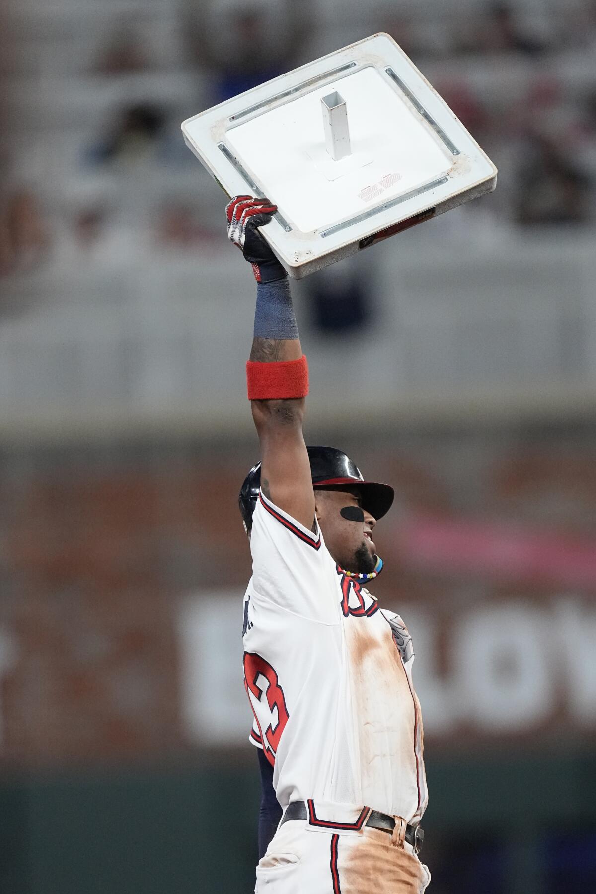 Braves' Ronald Acuna Jr. holds up a bag after stealing second base against the Chicago Cubs.