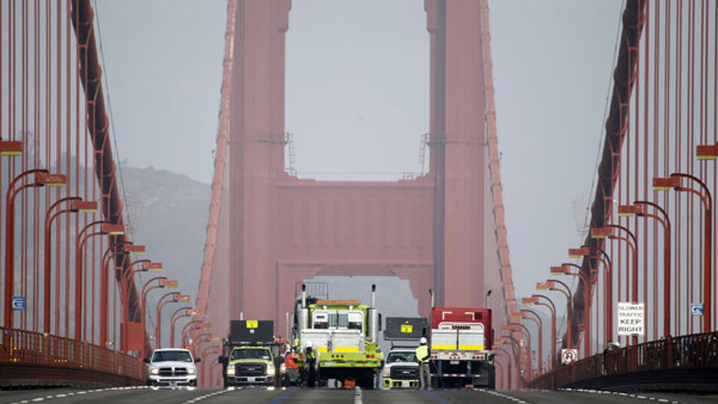 A road crew installs the movable median barrier on the Golden Gate Bridge.