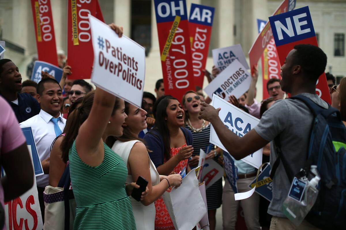 College students celebrate in front of the U.S. Supreme Court after a ruling was announced in favor of the Affordable Care Act.