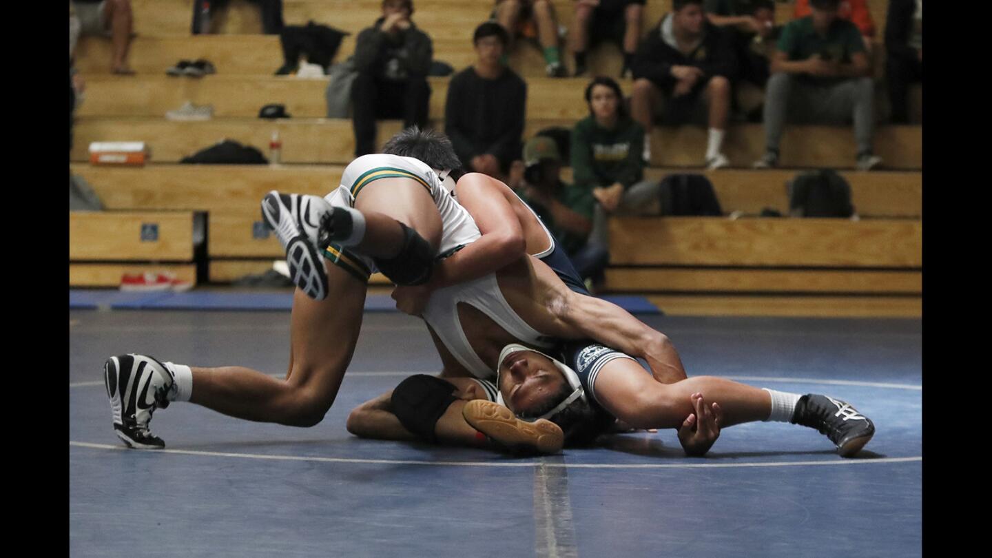 Edison's Anthony Loyola wrestles Newport Harbor's Ryan Pham in the 126 pround weight class during a meet on Wednesday, January 10.