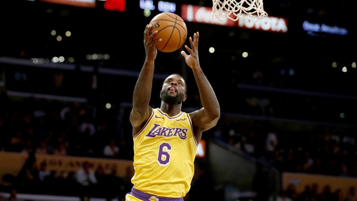 Lakers guard Lance Stephenson drives for a layup against the Denver Nuggets.