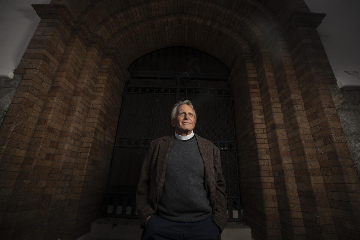 Father Thomas Carey stands for a portrait at Church of the Epiphany.