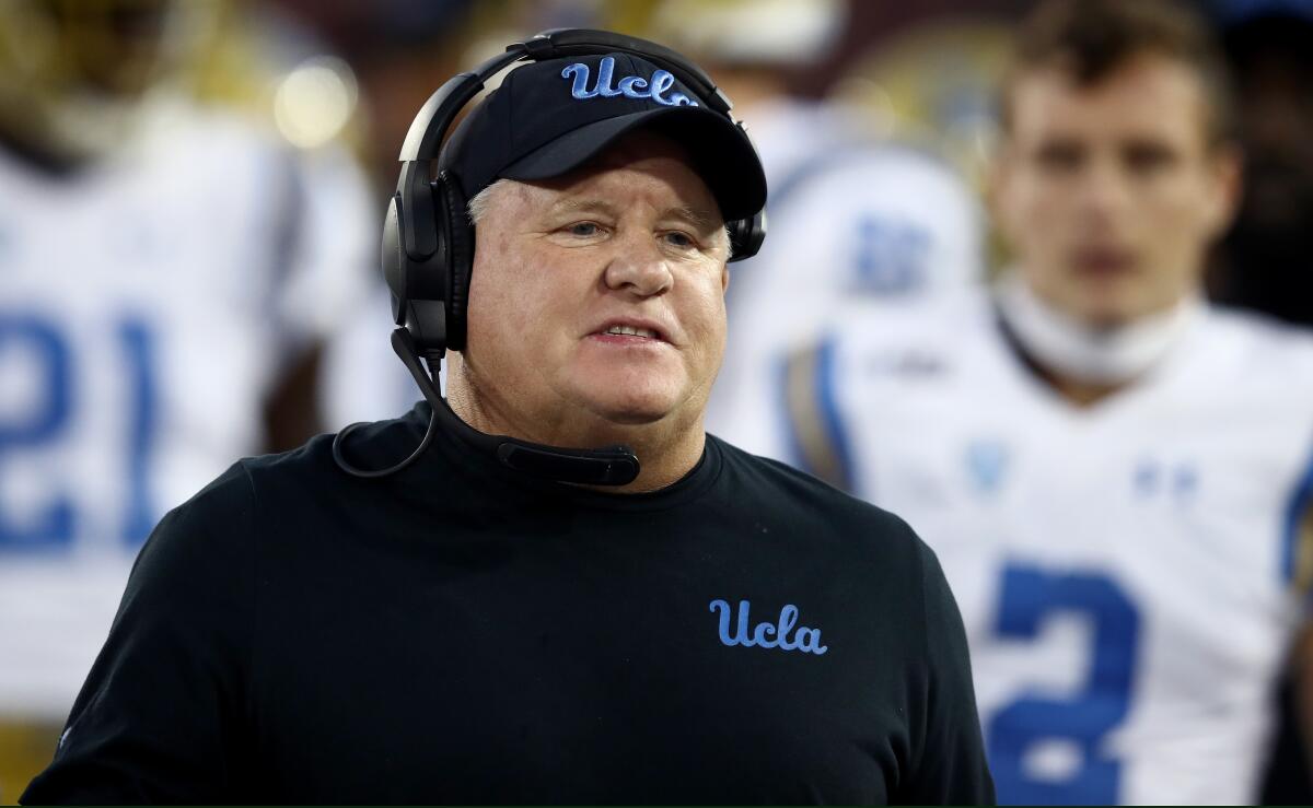 UCLA coach Chip Kelly stands on the sideline against Stanford.