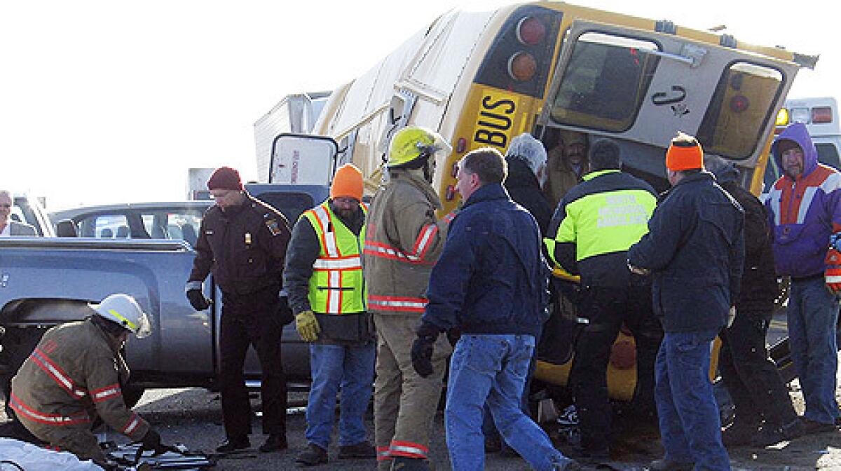 Rescue workers are seen at the site of a bus crash Tuesday Feb. 19, 2008 on Cottonwood, Minn. First-arriving motorists were forced to rush some of the injured to nearby hospitals.