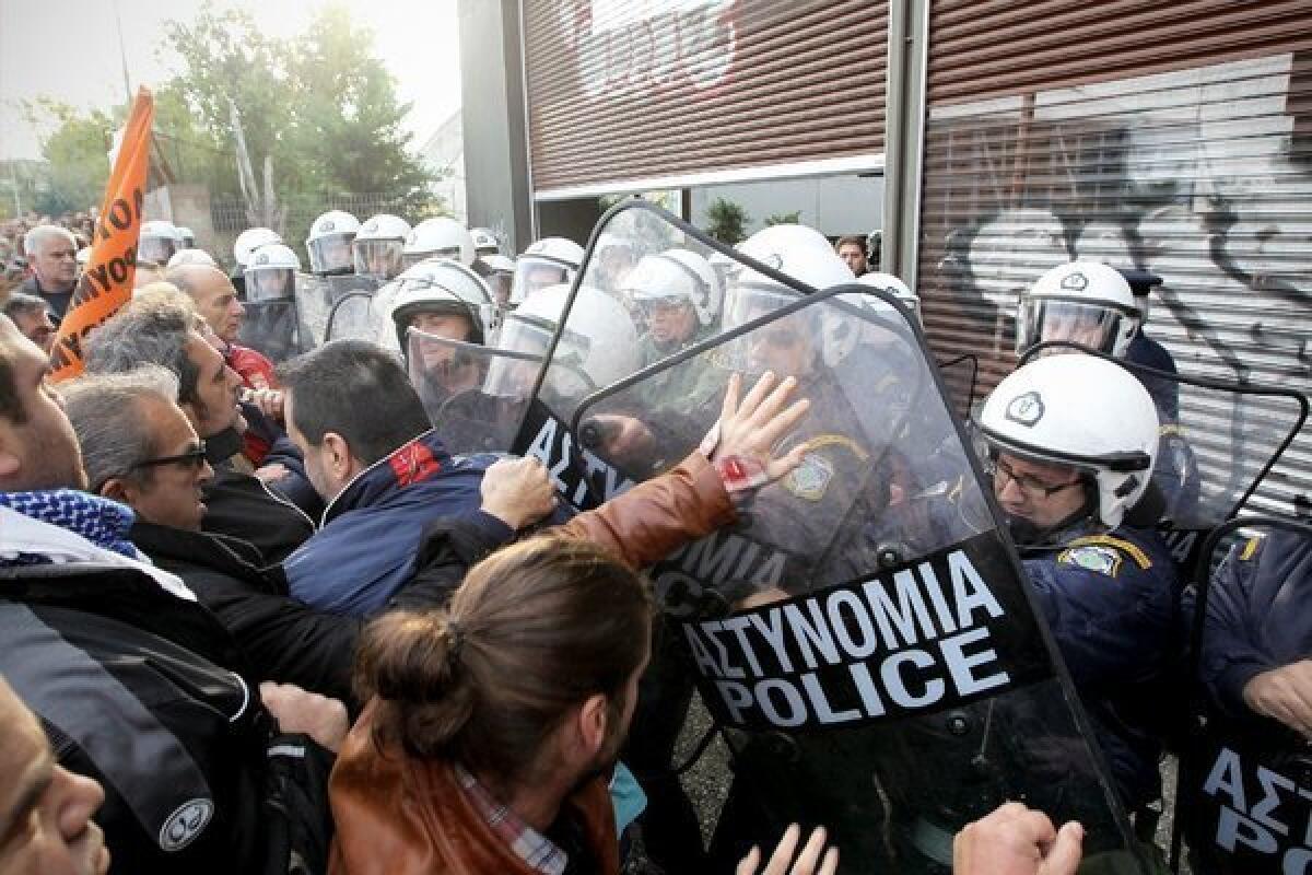 Protesting municipal workers clash with riot police in the port city of Thessaloniki, Greece, earlier this month.