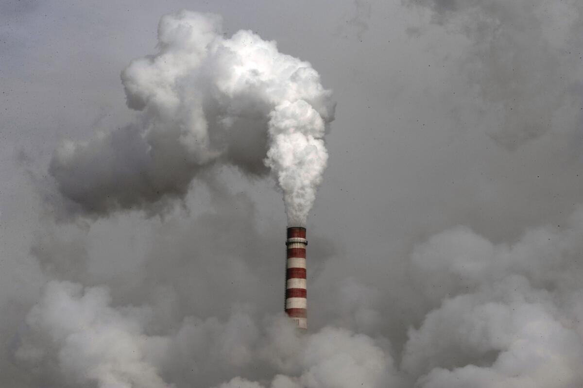 Smoke is emitted from a chimney of the cooling towers of a coal-fired power plant in Dadong, Shanxi province, China.