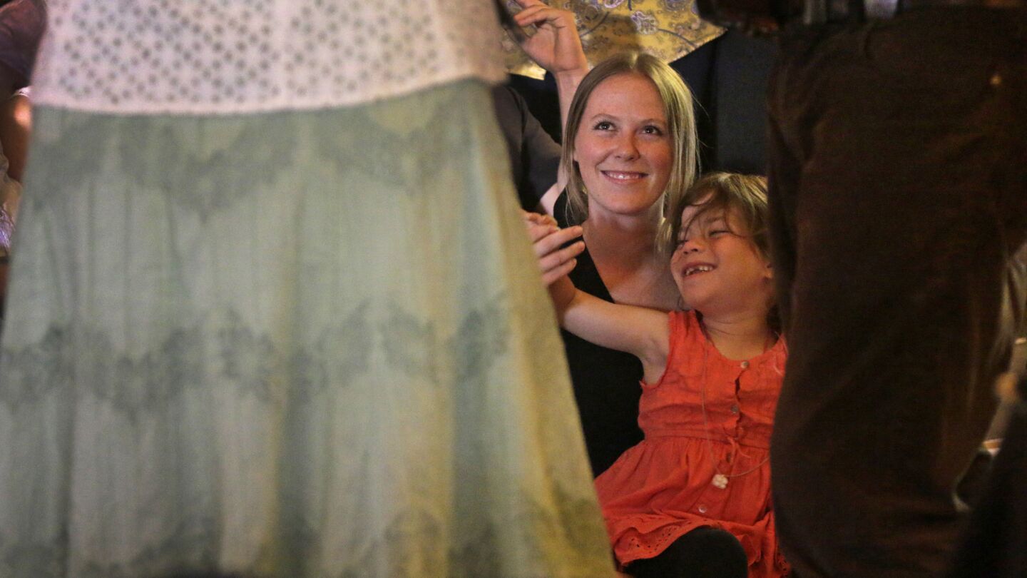 Christine Wood and Natalie Edmonds, 6, enjoy the performance by Beverly Smith and John Grimm.