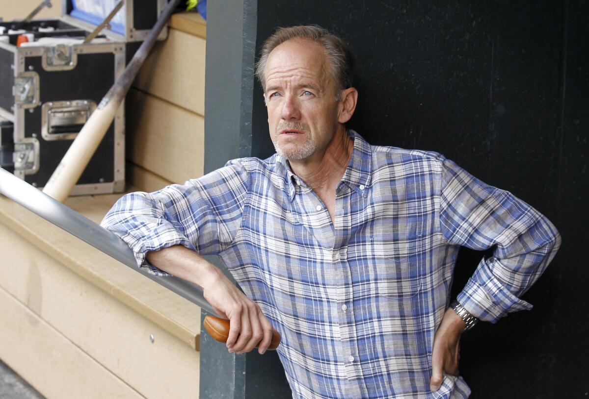 Minnesota Twins owner Jim Pohlad looks out from the dugout.