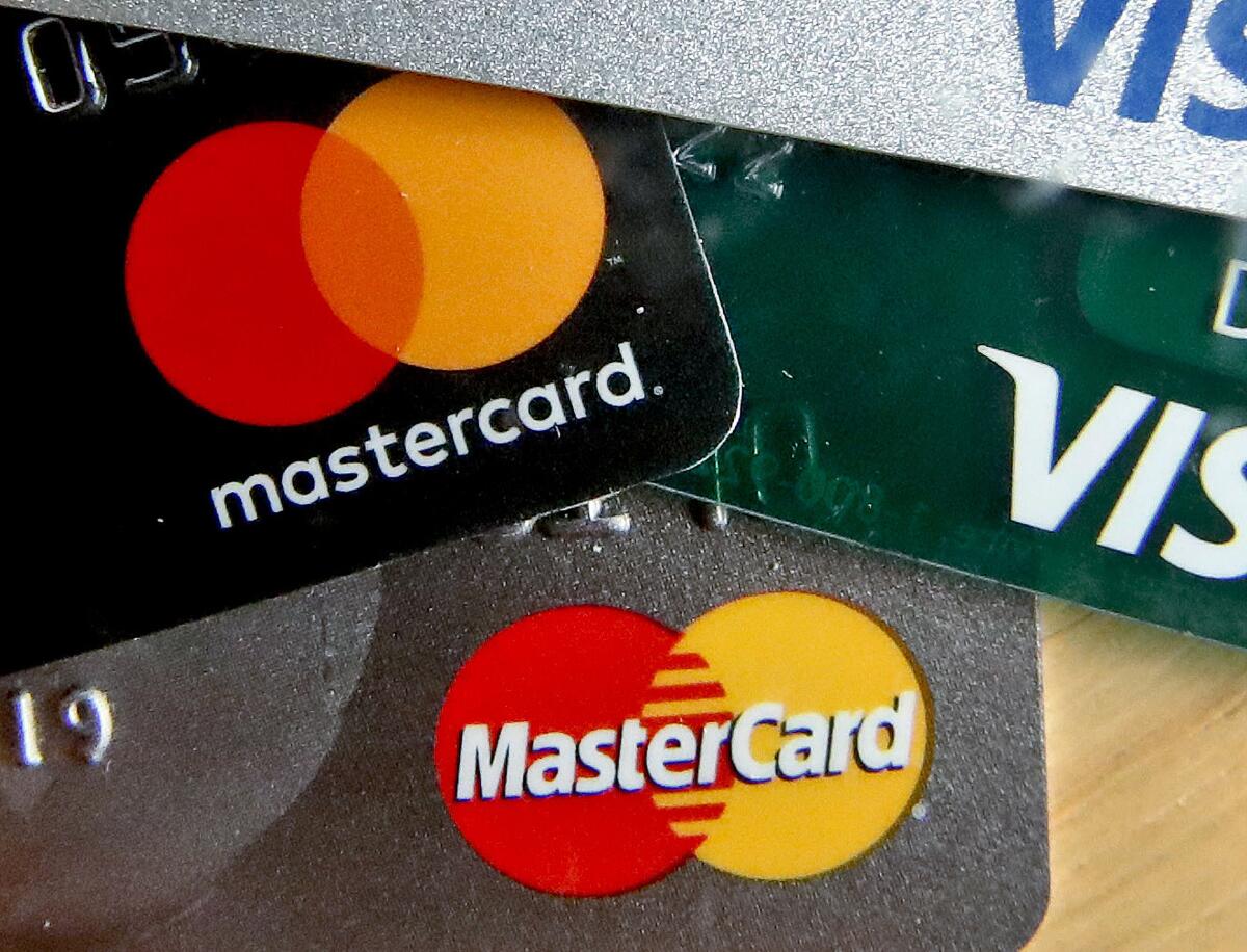A stack of MasterCard and Visa credit cards.