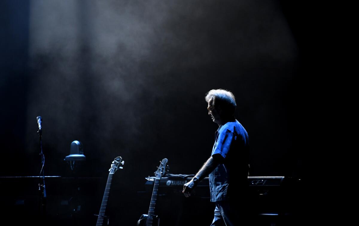 Eric Clapton walks onstage.