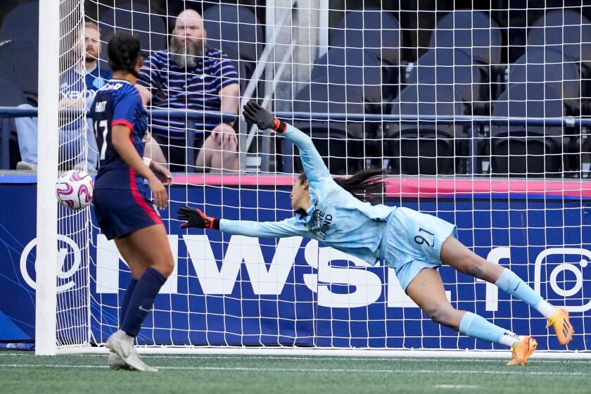 OL Reign goalkeeper Phallon Tullis-Joyce (91) cannot stop a goal by Portland Thorns midfielder Christine Sinclair as Reign defender Sam Hiatt (17) watches during the second half of an NWSL soccer match, Saturday, June 3, 2023, in Seattle. (AP Photo/Lindsey Wasson)