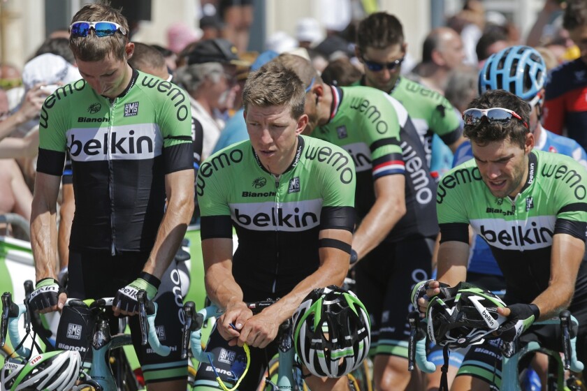 Dutch riders of the Belkin team wear black bands at the Tour de France in Chamrousse as participants observe a minute of silence for victims of the Malaysia jet downing.