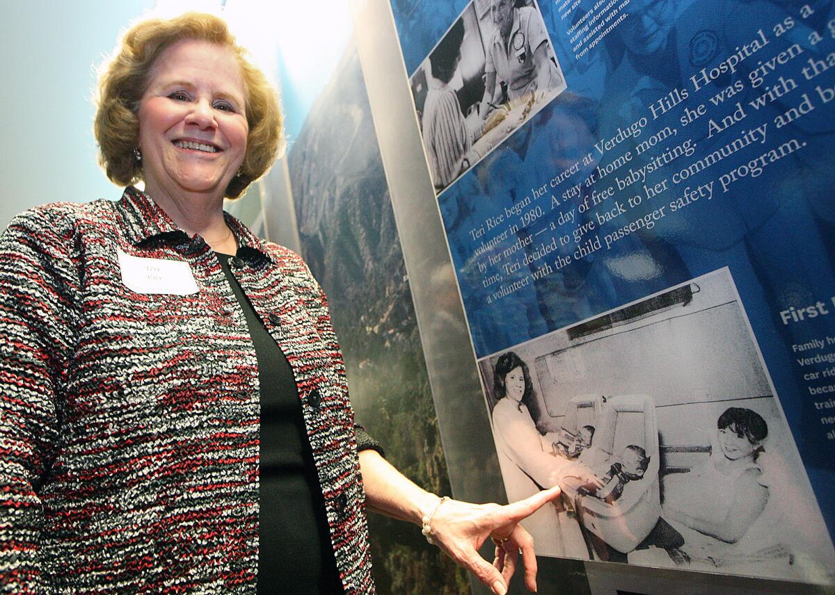 Teri Rice points of a photo of herself from 33 years ago on the Verdugo Hills Hospital history wall at the unveiling on Tuesday, March 31, 2015.