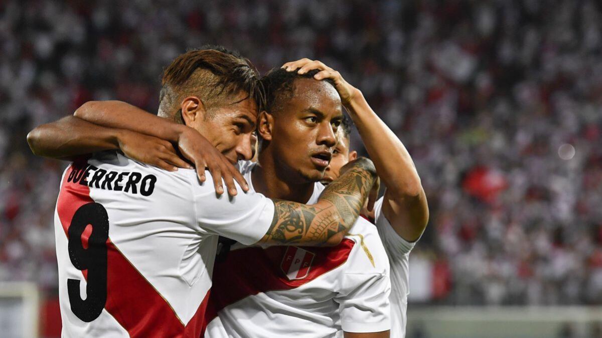 Peru's Paolo Guerrero, and Andre Carrillo, from left, react after Guerrero scored during a friendly soccer match between Saudi Arabia and Peru on Sunday.