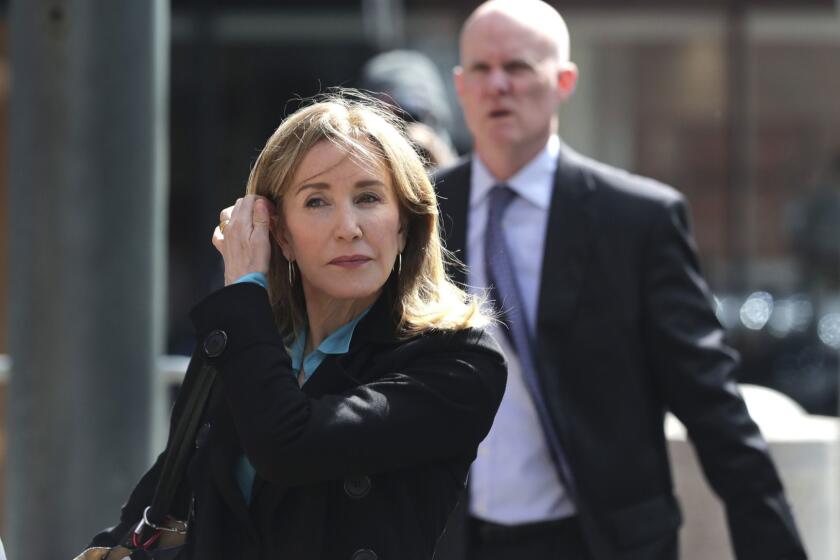 Actress Felicity Huffman arrives at federal court in Boston on Wednesday, April 3, 2019, to face charges in a nationwide college admissions bribery scandal. (AP Photo/Charles Krupa)