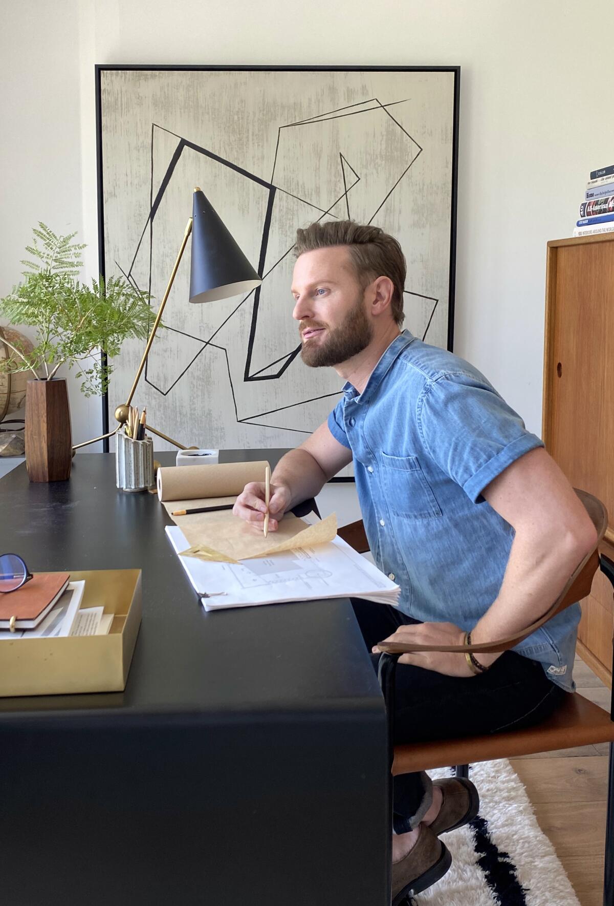 "Queer Eye" design expert Bobby Berk, pictured in his home office, will examine the Emmy winners' home decor.