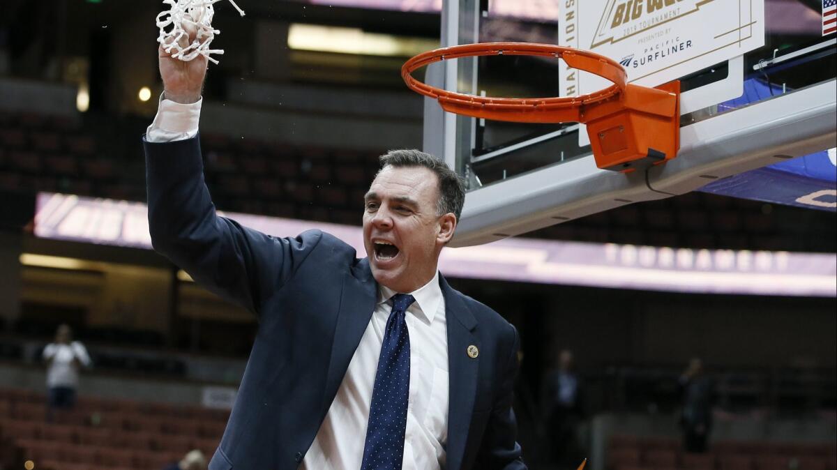 UC Irvine coach Russell Turner celebrates by cutting down the net after his team beat Cal State Fullerton in the Big West tournament title game Saturday.