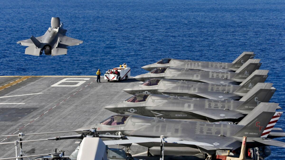 The F-35B fighter jet undergoes flight testing from the amphibious assault ship America.