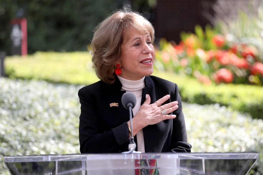 USC President Carol Folt speaks at a lectern 