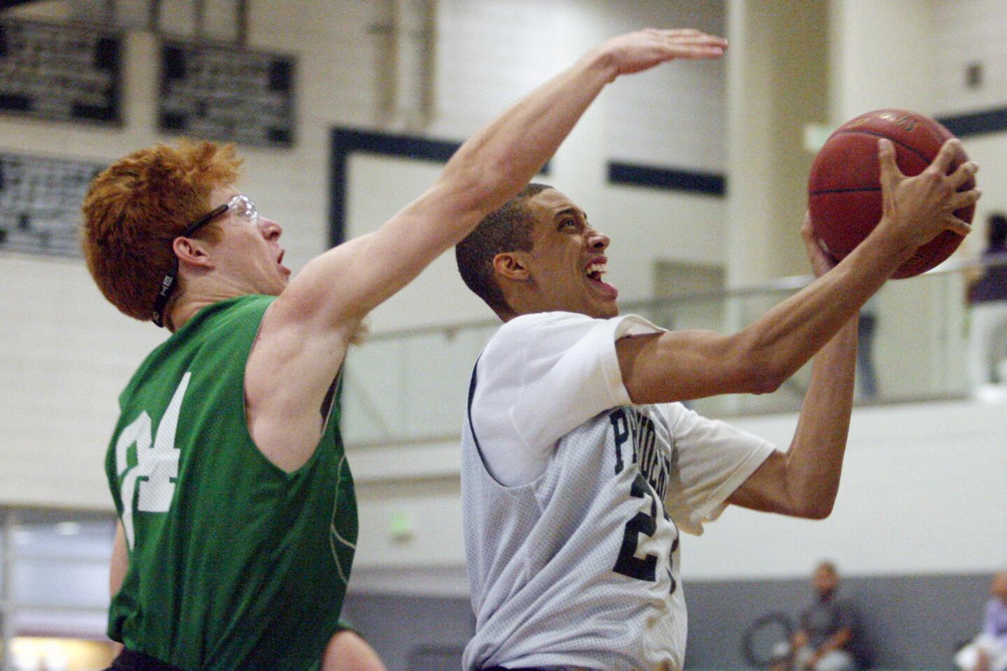 Providence's Christian Ware-Berry does a layup and is fouled by Reedley's Clay Kosinski during a game at Providence High School in Burbank on Saturday, July 21, 2012.