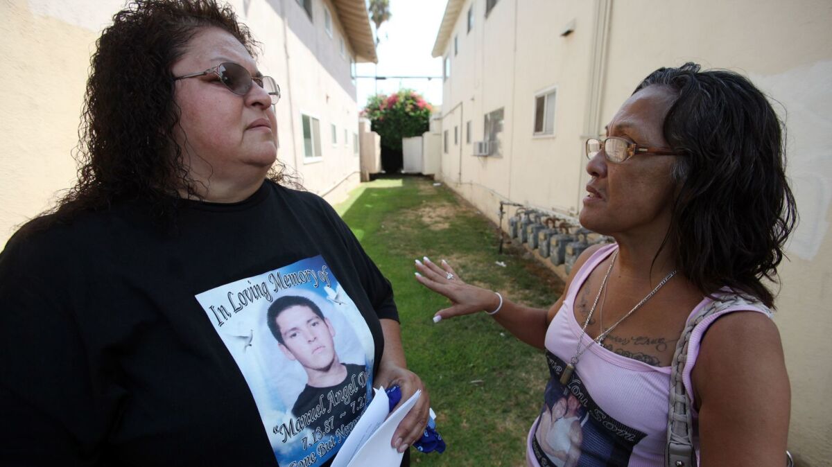 Manuel Angel Diaz's mother, Genevieve Huizar, left, speaks with Teresa Smith back in 2012. A federal jury decided Thursday that Anaheim police officer used excessive force when he gunned down a 25-year-old Diaz.