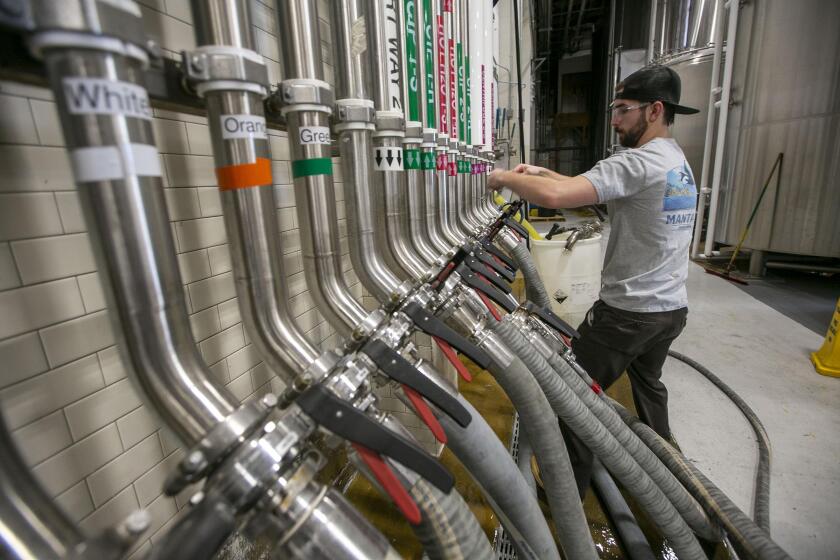 Filter Technician Alex Schaeffer works at the Ballast Point Brewery in Mira Mesa on Friday, December 6, 2019.