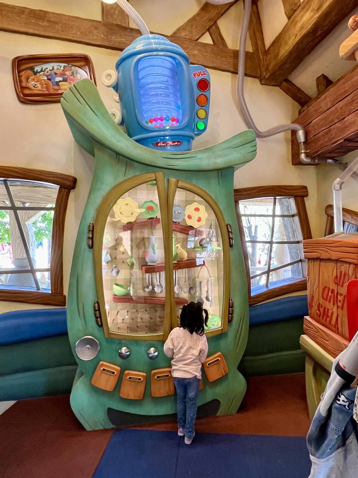 A young park guest plays in Goofy's How-to-Play Yard at Toontown.